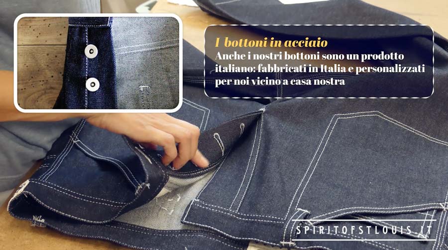 Applicazione dei bottoni in acciaio sui blue jeans Made in Italy di Spirit of St. Louis